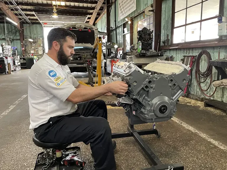 ASE-certified technician performing engine repair and engine replacement work at Harrell & Beverly Transmissions & Auto Repair in Sanford, Florida.